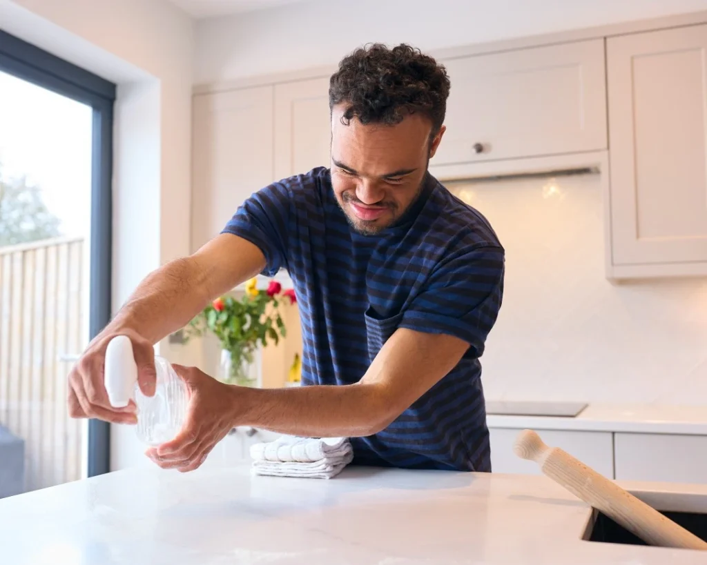 Disabled man cleaning the kitchen